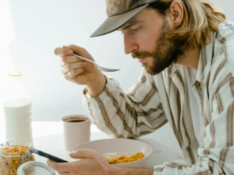 Man eating breakfast at a table.